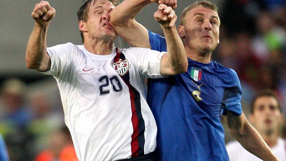 Daniele De Rossi (right) rearranging Brian McBride’s features.