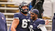 Sep 30, 2023; East Hartford, Connecticut, USA; UConn Huskies quarterback Ta'Quan Roberson (6) and UConn Huskies offensive lineman Christopher Fortin (67) warm up before the start of the game against the Utah State Aggies at Rentschler Field at Pratt & Whitney Stadium. Mandatory Credit: David Butler II-Imagn Images