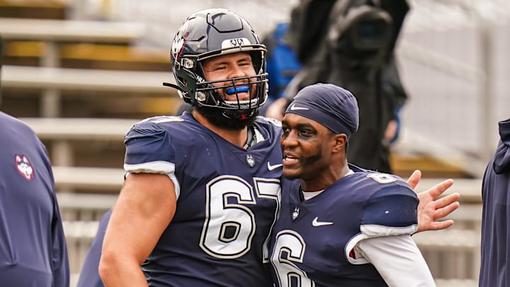 Sep 30, 2023; East Hartford, Connecticut, USA; UConn Huskies quarterback Ta'Quan Roberson (6) and UConn Huskies offensive lineman Christopher Fortin (67) warm up before the start of the game against the Utah State Aggies at Rentschler Field at Pratt & Whitney Stadium. Mandatory Credit: David Butler II-Imagn Images Sep 30, 2023; East Hartford, Connecticut, USA; UConn Huskies quarterback Ta'Quan Roberson (6) and UConn Huskies offensive lineman Christopher Fortin (67) warm up before the start of the game against the Utah State Aggies at Rentschler Field at Pratt & Whitney Stadium. Mandatory Credit: David Butler II-Imagn Images
