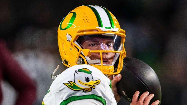 Oct 18, 2024; West Lafayette, Indiana, USA; Oregon Ducks quarterback Dillon Gabriel (8) throws a pass to warm up before the game against the Purdue Boilermakers at Ross-Ade Stadium. Mandatory Credit: Marc Lebryk-Imagn Images