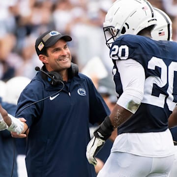 Penn State defensive coordinator Manny Diaz smiles as his unit comes to the sideline after creating a turnover against the Indiana Hoosiers at Beaver Stadium in 2023. 
