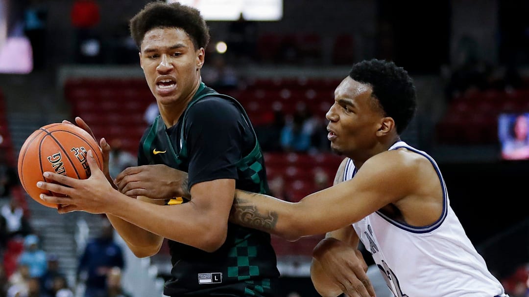 Freedom High School's Donovan Davis (24) is fouled by Milwaukee Academy of Science's Devin Brown (12) during the WIAA Division 3 state championship game on Saturday, March 22, 2025, at the Kohl Center in Madison, Wis. Milwaukee Academy of Science won the game, 57-54.