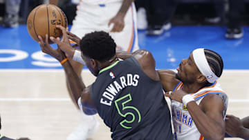 May 20, 2025; Oklahoma City, Oklahoma, USA; Minnesota Timberwolves guard Anthony Edwards (5) and Oklahoma City Thunder guard Shai Gilgeous-Alexander (2) fight for a rebound in the first quarter during game one of the western conference finals for the 2025 NBA Playoffs at Paycom Center. Mandatory Credit: Alonzo Adams-Imagn Images