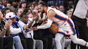 Nov 17, 2024; New York, New York, USA;  New York Knicks guard Jalen Brunson (11) crashes into actor and comedian Tracy Morgan in the fourth quarter against the Brooklyn Nets at Madison Square Garden. Mandatory Credit: Wendell Cruz-Imagn Images