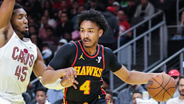 Nov 29, 2024; Atlanta, Georgia, USA; Atlanta Hawks guard Kobe Bufkin (4) drives the ball towards the goal against Cleveland Cavaliers guard Donovan Mitchell (45) during the first quarter at State Farm Arena. Mandatory Credit: Jordan Godfree-Imagn Images