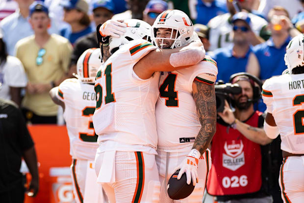  Miami Hurricanes TE Cam McCormick celebrates with OT Francis Mauigoa after scoring a touchdown against the Florida Gators.