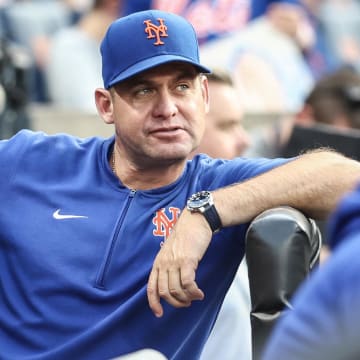 Aug 14, 2024; New York City, New York, USA;  New York Mets manager Carlos Mendoza (64) watches from the dugout prior to the game against the Oakland Athletics at Citi Field. Mandatory Credit: Wendell Cruz-USA TODAY Sports