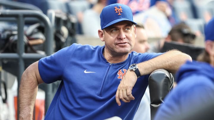 Aug 14, 2024; New York City, New York, USA;  New York Mets manager Carlos Mendoza (64) watches from the dugout prior to the game against the Oakland Athletics at Citi Field. Mandatory Credit: Wendell Cruz-USA TODAY Sports