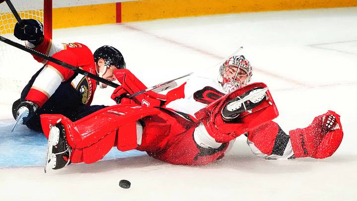 Sep 20, 2026; Sunrise, Florida, USA;  Carolina Hurricanes goalie Pyotr Kochetkov (52) makes a save against Florida Panthers forward Sandis Vilmanis (95) during the third period at Amerant Bank Arena.  Mandatory Credit: Jim Rassol-Imagn Images