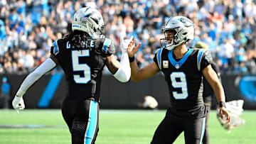 Nov 9, 2025; Charlotte, North Carolina, USA; Carolina Panthers running back Rico Dowdle (5) celebrates with quarterback Bryce Young (9) after scoring a touchdown in the first quarter at Bank of America Stadium. 