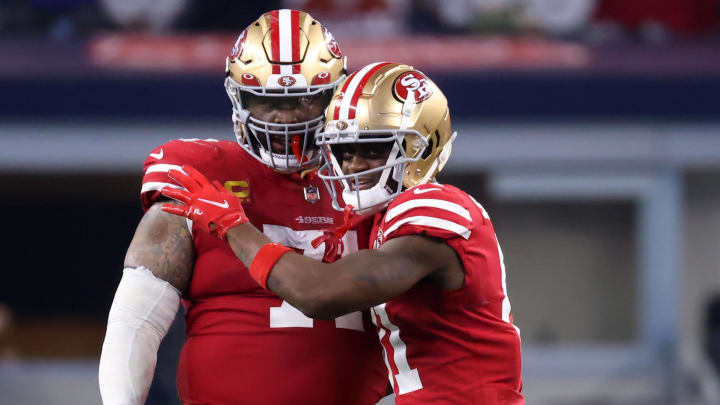 Jan 16, 2022; Arlington, Texas, USA; San Francisco 49ers wide receiver Brandon Aiyuk (11) and offensive tackle Trent Williams (71) celebrate on the field during the second half of the NFC Wild Card playoff football game against the Dallas Cowboys at AT&T Stadium. Mandatory Credit: Kevin Jairaj-USA TODAY Sports