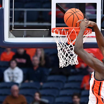Nov 8, 2025; Syracuse, New York, USA; Syracuse Orange forward William Kyle III (42) dunks the ball over Delaware State Hornets forward Cyril Obasogie (10) in the first half  at the JMA Wireless Dome. Mandatory Credit: Mark Konezny-Imagn Images