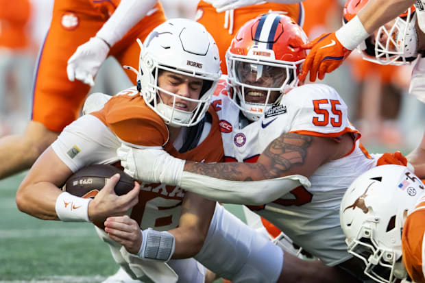 Texas Longhorns quarterback Arch Manning (16) is tackled by Clemson Tigers defensive tackle Payton Page (55).