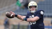 Notre Dame quarterback Riley Leonard (13) who is hurt, dresses and throws some pre-game passes with fellow quarterbacks Saturday, April 20, 2024, at the annual Notre Dame Blue-Gold spring football game at Notre Dame Stadium in South Bend.