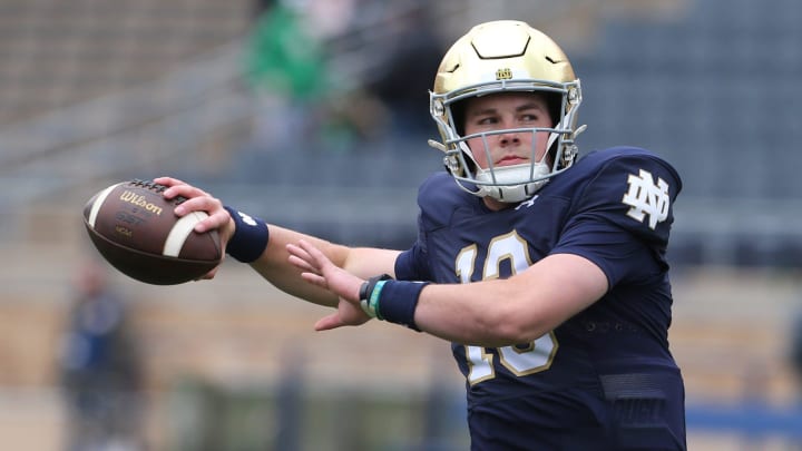 Notre Dame quarterback Riley Leonard (13) who is hurt, dresses and throws some pre-game passes with fellow quarterbacks Saturday, April 20, 2024, at the annual Notre Dame Blue-Gold spring football game at Notre Dame Stadium in South Bend.