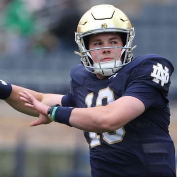 Notre Dame quarterback Riley Leonard (13) who is hurt, dresses and throws some pre-game passes with fellow quarterbacks Saturday, April 20, 2024, at the annual Notre Dame Blue-Gold spring football game at Notre Dame Stadium in South Bend.