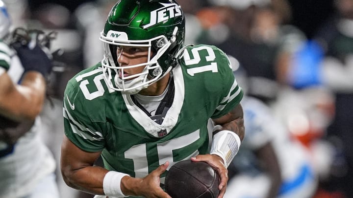 Aug 17, 2024; Charlotte, North Carolina, USA; New York Jets quarterback Adrian Martinez (15) drops back to hand off the ball against the Carolina Panthers during the second half at Bank of America Stadium. 