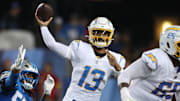 Jul 31, 2025; Canton, Ohio, USA; Los Angeles Chargers quarterback DJ Uiagalelei (13) throws against Detroit Lions defensive end Nate Lynn (57) in the fourth quarter at Tom Benson Hall of Fame Stadium. Mandatory Credit: Scott Galvin-Imagn Images