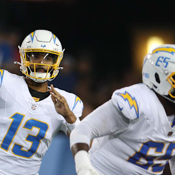 Jul 31, 2025; Canton, Ohio, USA; Los Angeles Chargers quarterback DJ Uiagalelei (13) throws against Detroit Lions defensive end Nate Lynn (57) in the fourth quarter at Tom Benson Hall of Fame Stadium. Mandatory Credit: Scott Galvin-Imagn Images