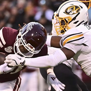 Mississippi State Bulldogs running back Davon Booth (21) runs against  Missouri Tigers linebacker Triston Newson (14) during the second quarter at Davis Wade Stadium at Scott Field.