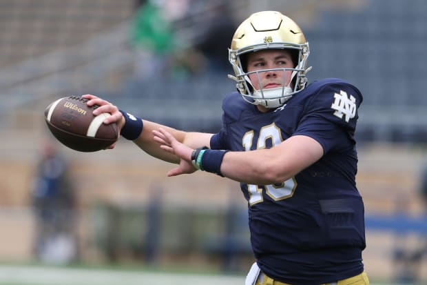 Notre Dame quarterback Riley Leonard dresses and throws pre-game passes with fellow quarterbacks at the Blue-Gold spring game