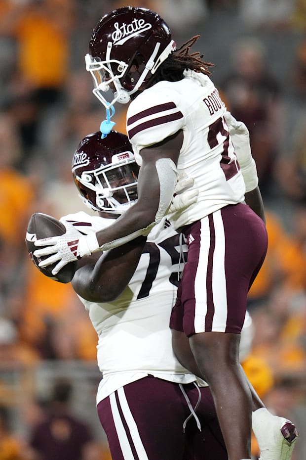 Bulldogs offensive lineman Jacoby Jackson (75) lifts up teammate Davon Booth (21) after his rushing touchdown