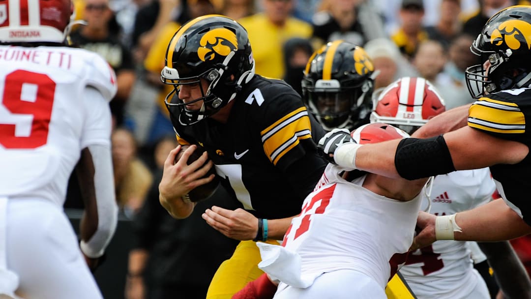 Sep 4, 2021; Iowa City, Iowa, USA; Iowa Hawkeyes quarterback Spencer Petras (7) runs for a 9 yard touchdown against the Indiana Hoosiers during the second quarter at Kinnick Stadium. Mandatory Credit: Jeffrey Becker-Imagn Images