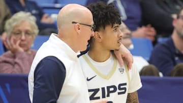 University of Akron head coach John Groce talks with Sharron Young