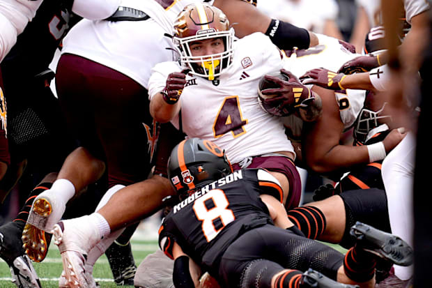 Arizona State running back Cam Skattebo getting tackled by Parker Robertson against Oklahoma State.