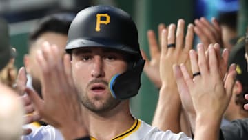 Jun 30, 2025; Pittsburgh, Pennsylvania, USA;  Pittsburgh Pirates catcher Joey Bart (14) high-fives in the dugout after scoring a run against the St. Louis Cardinals during the fifth inning at PNC Park. Mandatory Credit: Charles LeClaire-Imagn Images