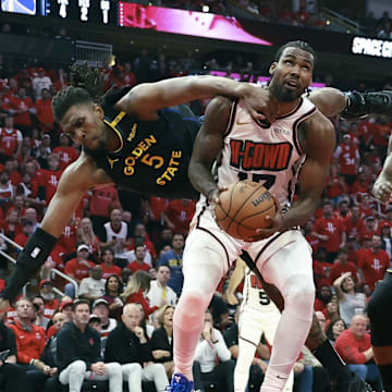 May 4, 2025; Houston, Texas, USA; Golden State Warriors forward Kevon Looney (5) falls to the ground as Houston Rockets forward Tari Eason (17) attempts to score during the third quarter of game seven of the first round for the 2025 NBA Playoffs at Toyota Center. Mandatory Credit: Troy Taormina-Imagn Images