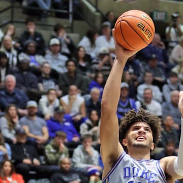 Nov 11, 2025; West Point, New York, USA; Duke Blue Devils forward Cameron Boozer (12) puts up a shot over Army Black Knights forward Jacen Holloway (10) during the second half at Christl Arena. Mandatory Credit: Danny Wild-Imagn Images