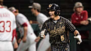 Mike Mancini celebrates Vanderbilt's 12-2 win after he drew a walk in the eighth inning and the bases loaded. 
