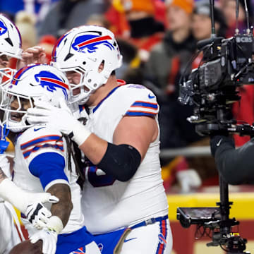 Jan 26, 2025; Kansas City, MO, USA; Buffalo Bills running back James Cook (4) celebrates with offensive tackle Spencer Brown (79) and guard Connor McGovern (66) after rushing for a touchdown against the Kansas City Chiefs during the first half in the AFC Championship game at GEHA Field at Arrowhead Stadium. 