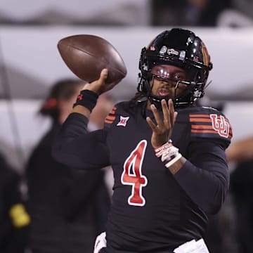 Utah Utes quarterback Devon Dampier (4) warms up before the game against the Cincinnati Bearcats at Rice-Eccles Stadium.