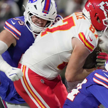 Buffalo Bills defensive end Michael Hoecht wraps up Kansas City Chiefs tight end Travis Kelce while Buffalo Bills safety Cole Bishop and cornerback Jordan Hancock join in in bringing Kielce down during first half action against the Kansas City Chief sat Highmark Stadium in Orchard Park on Nov. 2, 2025.