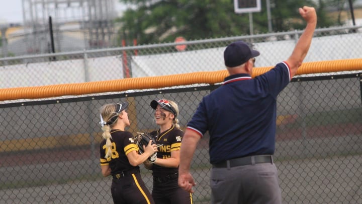 Watkins Memorial's Kyliee Trouten and Grace Whitman celebrate Whitman's diving catch on Friday, May 24, 2024.