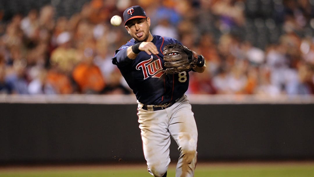 July 22, 2010; Baltimore, MD, USA; Minnesota Twins third baseman Nick Punto makes a throw to first base against the Baltimore Orioles at Oriole Park at Camden Yards.  Mandatory Credit: Rafael Suanes-Imagn Images