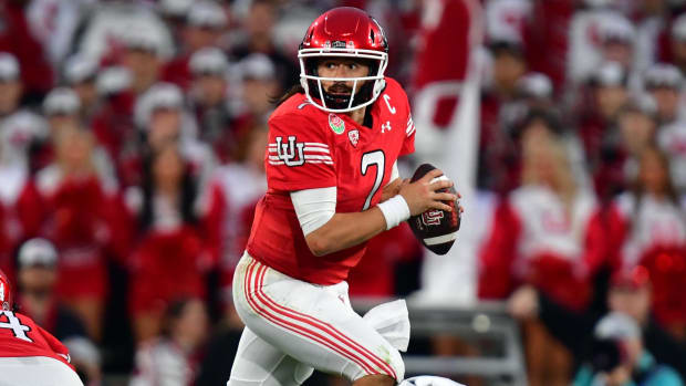 Utah Utes quarterback Cameron Rising attempts a pass during a college football game.
