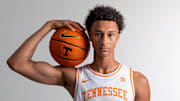 Nate Ament flexing with a Tennessee basketball
