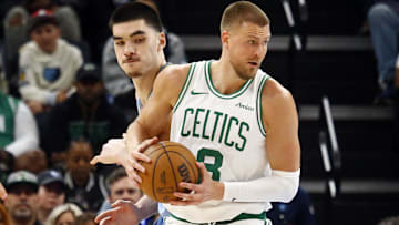 Boston Celtics center Kristaps Porzingis (8) spins to the basket as Memphis Grizzlies center Zach Edey (14) defends during the fourth quarter at FedExForum.