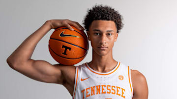 Nate Ament flexing with a Tennessee basketball