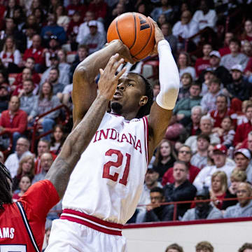 Indiana Hoosiers forward Mackenzie Mgbako (21) shoots the ball while Rutgers Scarlet Knights guard Jeremiah Williams (25)  defends in the first half at Simon Skjodt Assembly Hall.
