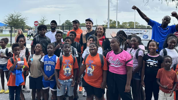 Orlando Magic guard Cole Anthony poses with a group of kids at his Back-to-School Surprise Wednesday night.