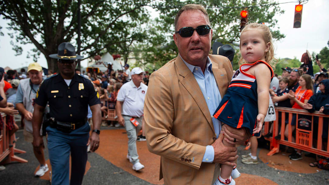 Auburn Tigers head coach Hugh Freeze holds his granddaughter, Hudson Blair Reynold, during Tiger Walk before Auburn Tigers take on Ball State Cardinals at Jordan-Hare Stadium in Auburn, Ala. on Saturday, Sept. 6, 2025.