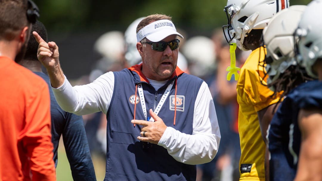 Auburn Tigers head coach Hugh Freeze talks with wide receiver Cam Coleman (8) during practice at Woltosz Football Performance Center in Auburn, Ala. on Thursday, Aug. 14, 2025.