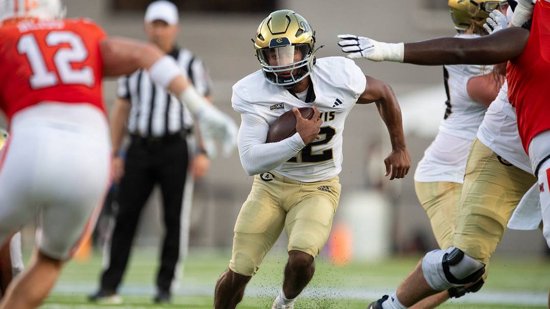UC Davis Aggies quarterback Caden Pinnick (12) runs the ball as Mercer Bears take on UC Davis Aggies during the FCS Kickoff Game at Cramton Bowl in Montgomery, Ala. on Saturday, Aug. 23, 2025.