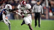 Alabama Crimson Tide running back Jam Miller (26) runs the ball as Auburn Tigers take on Alabama Crimson Tide in the Iron Bowl at Jordan-Hare Stadium in Auburn, Ala. on Saturday, Nov. 29, 2025. Alabama Crimson Tide leads Auburn Tigers 17-6.