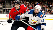 Coachella Valley Firebirds forward Ryan Winterton (27), left, and Colorado Eagles forward Cedric Pare (65) battle for the puck at Acrisure Arena in Palm Desert, Calif., on Sun., Dec. 17, 2023.