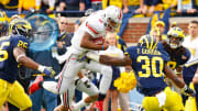 Ohio State Buckeyes quarterback Braxton Miller (5) splits Michigan Wolverines linebacker Kenny Demens (25) and Michigan Wolverines safety Thomas Gordon (30) during a touchdown run in the 2nd quarter during their NCAA college football game in Michigan Stadium, Ann Arbor, Michigan November 26, 2011. (Dispatch photo by Kyle Robertson)

Osu11um Kr 06